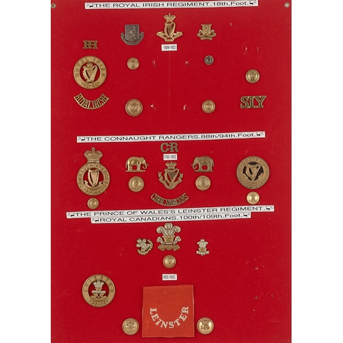 298 - Royal Irish, Connaught Rangers and Leinster badges, shoulder titles etc.  Board with good display of... 