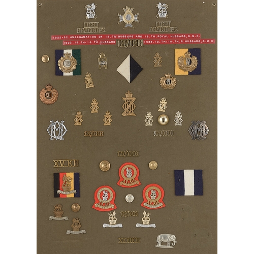 301 - Hussar badges, shoulder titles etc.  Board with good display of approx. 45 metal insignia including ... 