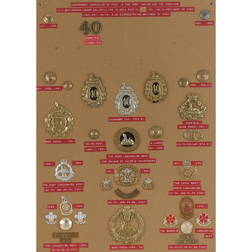 307 - 40th Foot and South Lancashire badges, shoulder titles etc.  Board with good display of approx. 33 m... 