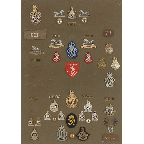 308 - Hussar badges, shoulder titles etc.  Board with good display of approx. 48 metal and cloth insignia ... 