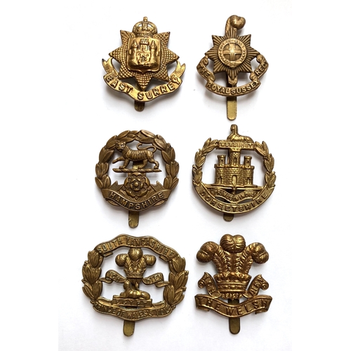 317 - 6 All brass 1916 economy issue Infantry cap badges.  East Surrey ... R. Sussex ... Hampshire ... Dor... 