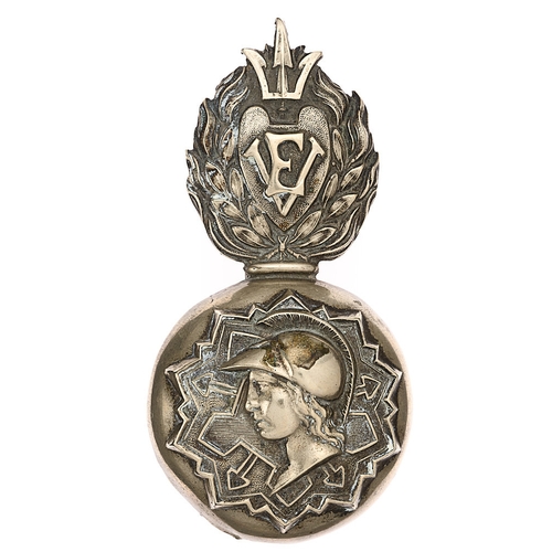 1st Middlesex Engineer Volunteers Victorian busby plume holder grenade badge c. 1860-71.  Good rare die-stamped white metal flaming grenade, the domed ball bearing a plan of fortification on which is superimposed the head of Mars. The flames bear heart shaped shield with EV cypher; emerging from behind the shield, a trident.     Long slider and provision for plume.  Minor service wear GC.