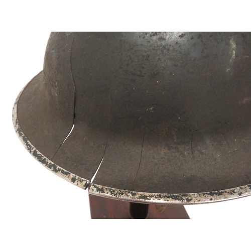 191 - Two British Home Front Steel Helmets
consisting grey painted example.  Each brim side with four... 