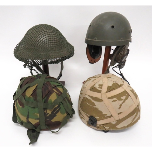 202 - Four Various Post War Helmets
consisting British MK6, fibre, combat helmet complete with DPM camo co... 