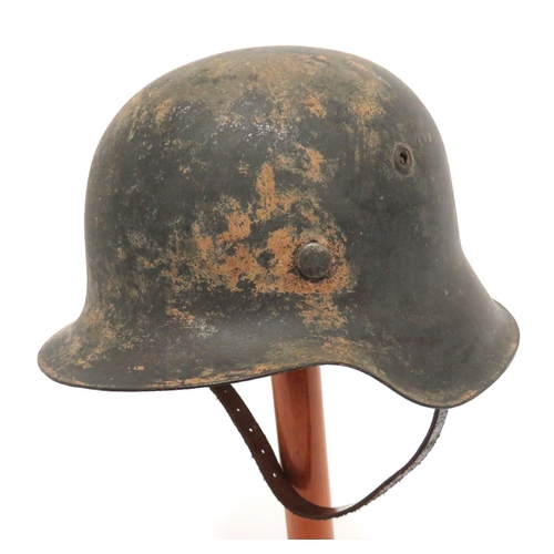 337 - German M1942 Raw Edge Steel Helmet
steel crown with lower raw edge brim.  Traces of green paint... 