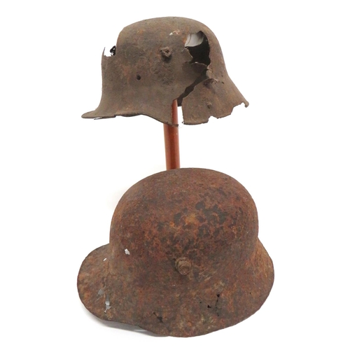 338 - Two Imperial German Relic Steel Helmets
consisting M1916 example.  The side with large shrapnel... 