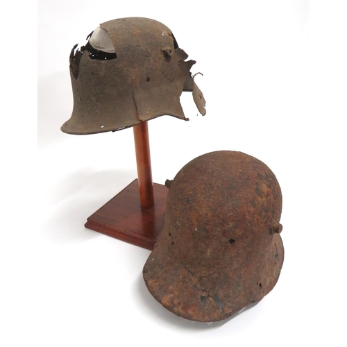 338 - Two Imperial German Relic Steel Helmets
consisting M1916 example.  The side with large shrapnel... 