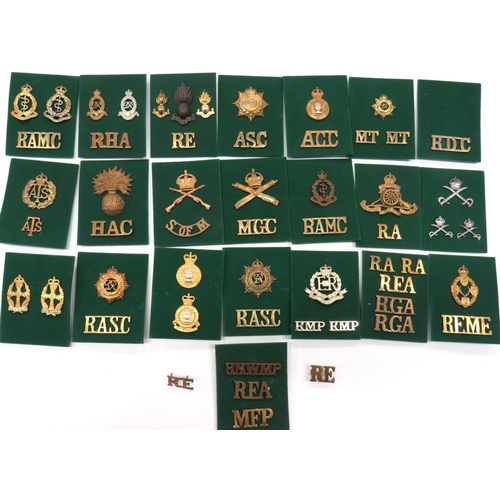 80 - 55 x Corps Cap, Collar And Shoulder Titles
cap include brass KC MGC ... White metal KC Army Physical... 