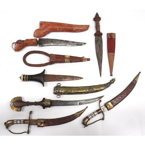 511 - Six Various Eastern Knives
including jambiya with wooden grip and brass comb pommel.  Contained in i... 