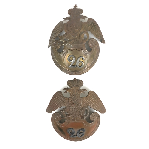 2 Russian 26th Regiment (Mogilev Infantry Regiment) Crimean helmet plates c. 1850's.  Good scarce die-stamped large brass Imperial double headed eagle with shield to breast bearing St. George and the Dragon. The Amazon shield base with original stencilled number replaced with applied brass shield bearing lead numerals 26. Reverse bears old faded ink hand-written paper label "From the Battle of Alma 1854" ...  similar example, lacking cross on crown,  not renumbered but with numeral placed directly onto the plate, no label. Both lacking fittings.