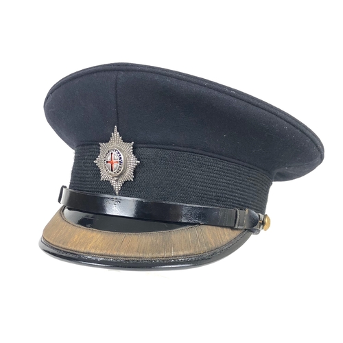 306 - Coldstream Guards Officer's peaked forage cap  bearing silver badge.  Dark blue melton cloth body wi... 