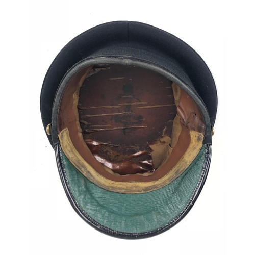 306 - Coldstream Guards Officer's peaked forage cap  bearing silver badge.  Dark blue melton cloth body wi... 