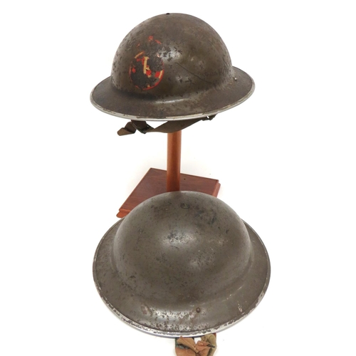 159 - Two Early WW2 MKII Steel Helmets
consisting green painted example.  Traces of AFS transfer to t... 