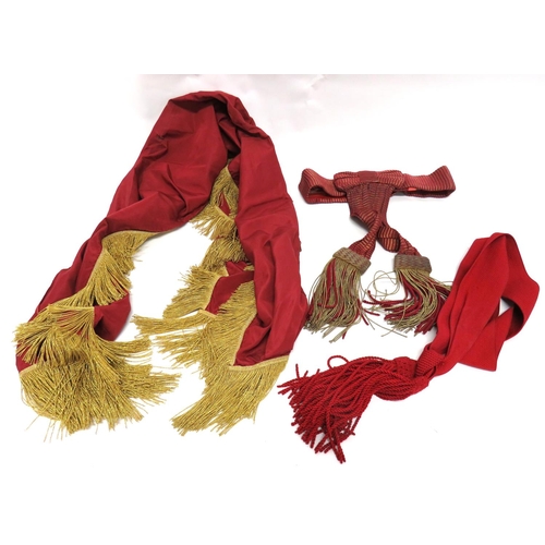 200 - Three Various Military Sashes
consisting State Trumpeter's apron sash in maroon silk with gilt braid... 