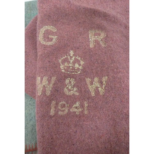 229 - Two 1941 Dated Military Issue Blankets
consisting a grey woollen blanket and a light red woollen bla... 