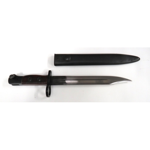 British No 5 MKI Jungle Carbine Bayonet
8 inch, single edged, clipped point blade with fuller. &nbsp;Forte stamped "W.S.", possibly dated "43". &nbsp;Large, blackened muzzle ring, crossguard and pommel. &nbsp;Wooden slab grips. &nbsp;Contained in its blackened steel scabbard. &nbsp;