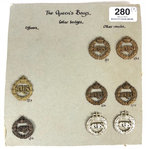 Queen's Bays card of 8 items of insignia plus others. Officer's gilt single ... OSD bronze single ... pair of Victorian OR's ... pair of 1901-52 OR's ... pair of anodised. All complete with fittings. (8 items) GC