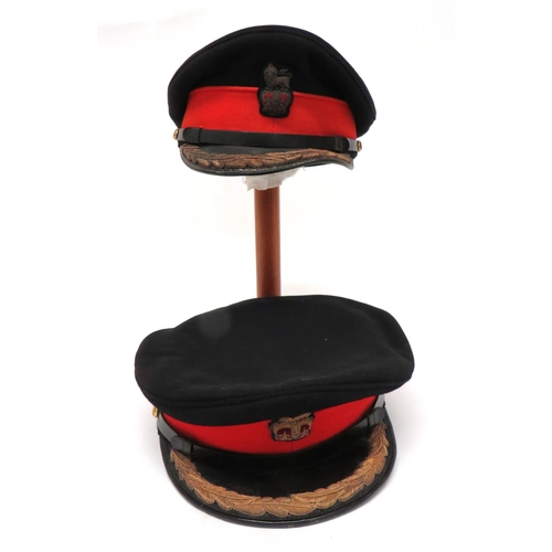 Two Post 1953 Brigadier Full Dress Caps
black crown, red band, black patent peak with gilt wire embroidery oak leaf badge.  Black patent chinstrap.  Bullion embroidery, QC Brigadier's badge.  Leather sweatband.  2 items.  Minor moth nips.  