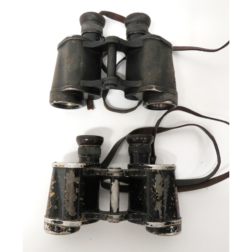 Two Pairs Of Third Reich WW2 German Dienstglas Binoculars
consisting black, overpainted sand alloy frame examples.  Top frames marked "Dienstglas 6 x 30" with maker "CAG".  Complete with leather strap ... Similar, black painted pair.  Top frames marked "Dienstglas 6 x 30" with maker 'DDX".  Broken leather strap.  2 items.