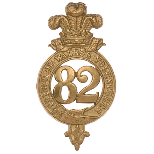 82nd (Prince of Wales's Vols) Regiment of Foot Victorian glengarry badge c. 1874-81.  Good die-stamped brass strap PRINCE OF WALES’S VOLUNTEERS surmounted by Prince of Wales's plumes; 82 to voided centre.     Brass loops East & West.  Minor service wear. GC  Became 2nd Bn. South Lancashire Regt. on Friday 1st July, 1881.