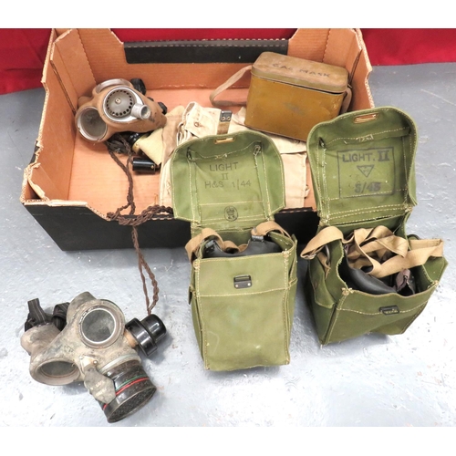 Selection Of Respirators And Accessories
including telephone operator's mask complete with microphone and headset ... Civilian mask complete in tin transit box ... 2 x light pattern respirators complete in green webbing transit bags ... 1940 dated, military pattern (mask only) ... 2 x canvas transit bags.