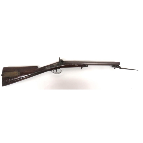 Fine Mid 19th Century Double Barrel Carbine With Spring Bayonet By Eden Smith
.700, 16 inch, browned Damascus side by side barrels. &nbsp;Top rib with maker "Eden Smith. &nbsp;Side mounted ramrod pipes holding the brass ended wooden ramrod. &nbsp;Lower mounted, triangular form spring bayonet. &nbsp;Back action lock plates. &nbsp;Steel percussion hammers. &nbsp;Polished, half stock woodwork with checkered wrist. &nbsp;Steel butt plate, trigger guard and bayonet release catch. &nbsp;The butt with Baker style, brass, rectangular patchbox. &nbsp;