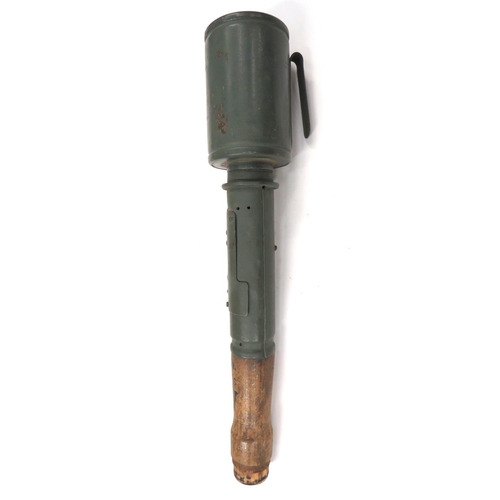 German Pattern Inert M1917 Stick Grenade
green painted, canister head with rear fitted belt hook. &nbsp;Lower steel plate handle with removable panel. &nbsp;Short wooden stick handle with various black stencilled numbers. &nbsp;Lower base cover absent.