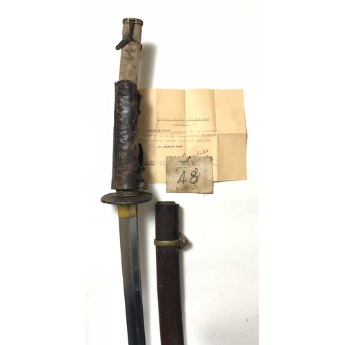 WW2 Japanese Katana Officer's Used Sword.Bring Back Example  This Sword was brought back by Sergeant W A Miles Suffolk (Cambridge Bn) Regiment who had been captured in May 1942.The 28 3/4 inch single edged blade, with a wavy hammon.  The tang is unsigned, with two securing holes. Gilt copper habaki, steel tsuba, with copper and gilt animal decoration Civilian darkened and brass fuchi and kabuto gane. each with insect decoration. The grip with white shagreen grip lacking cord binding and mounts, retaining part of the leather field service coverComplete with in original wooden civilian laquered scabbard with brass hanging ring and lower steel ishizuke (Chape) with gilt floral decoration. The grip possible damaged by bullet strike.Accompanied by an original bring back certificate dated 10th December 1945 with typed name. Also a cloth numbered badge, probably POW badge.        6020448 Sergeant W A Miles is confirmed as serving with the Suffolk Regiment noted as with the Cambridge Bn when on the 1st May 1942 he was captured. Further information indicates after liberation he remained at his camp to help identify Japanese war criminals amongust the Officers and guards. When he was due to return he was taken to a room with captured Japanese swords and was able to choose one to bring back home.  PAYMENT BY BANK TRANSFER ONLY
