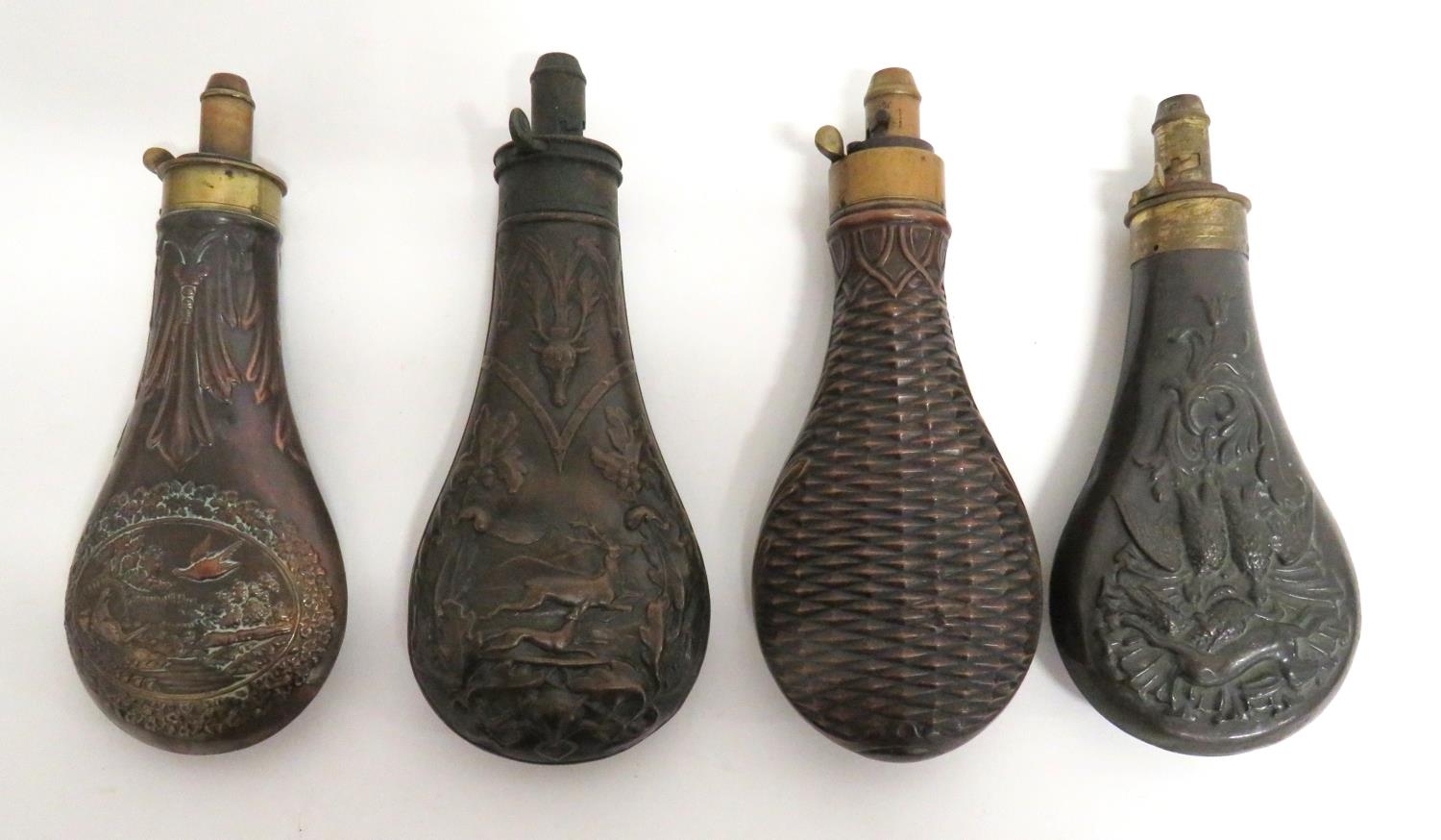 Four Mid 19th Century Copper Bodied Powder Flasks consisting copper ...