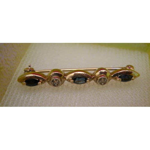 27 - 9ct yellow gold brooch with 3 sapphires & 2 small diamonds, approx 2.3 grams gross.

P & P – UK £10+... 