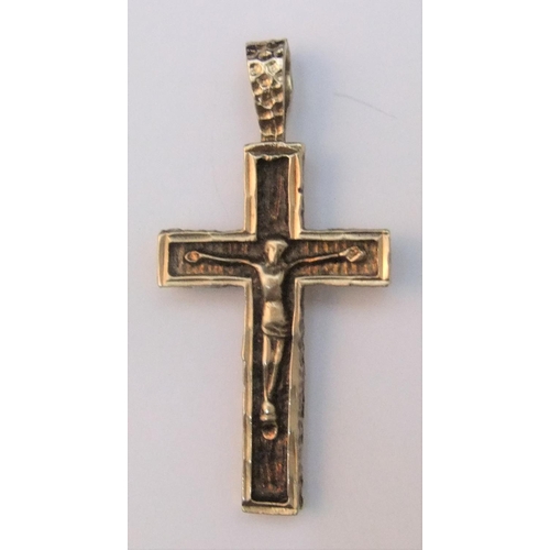 19 - 9ct yellow gold pendant, double sided cross.

One side depicts Jesus on the cross the other modernis... 