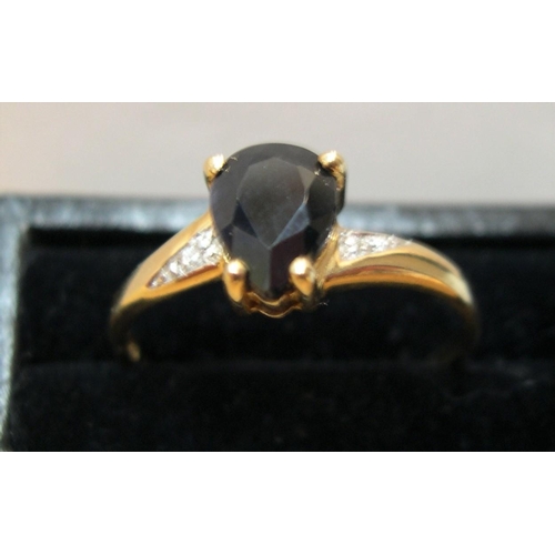 25 - 9ct gold ring with a tear drop sapphire with diamonds

1.6 grams gross,    size P/Q