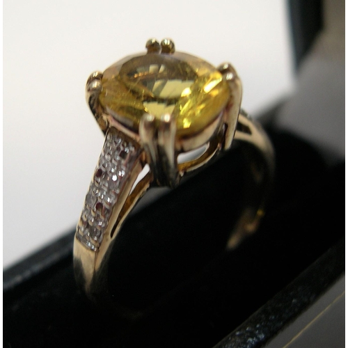 32 - 9ct gold and yellow stone ring in claw set mount with the sides set with diamonds, 

2.6 grams gross... 