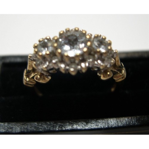 36 - 9ct gold and diamond cluster ring, the main 3 diamonds set raised in a central line with the central... 