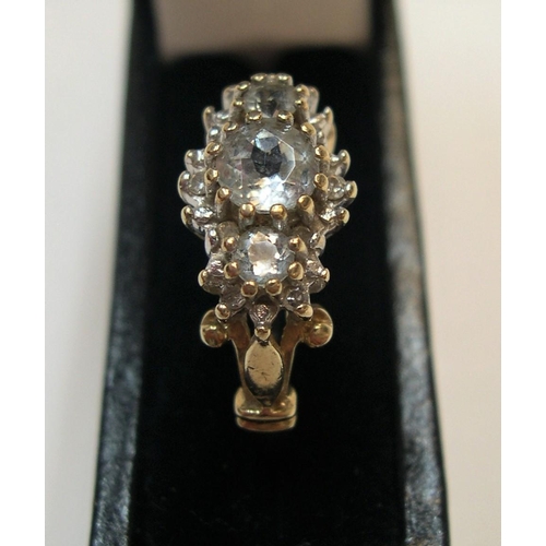 36 - 9ct gold and diamond cluster ring, the main 3 diamonds set raised in a central line with the central... 