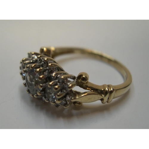 36 - 9ct gold and diamond cluster ring, the main 3 diamonds set raised in a central line with the central... 