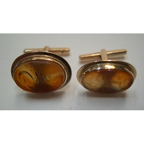 39 - Pair of imported yellow gold (stamped 14 carat) & agate cufflinks, with Arabic/Eygptian script 

8.4... 