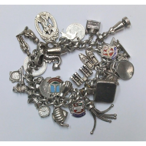 113 - Old silver charm bracelet adorned with approx 33 silver charms and an EPNS nurses' belt buckle

The ... 