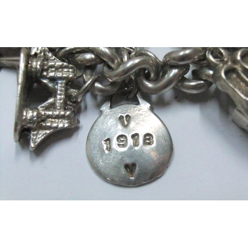 113 - Old silver charm bracelet adorned with approx 33 silver charms and an EPNS nurses' belt buckle

The ... 