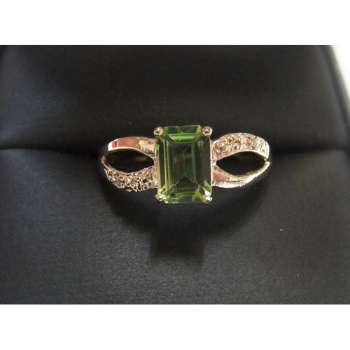 87 - 9ct yellow imported gold ring with octagon cut peridot & with small set diamonds to both shoulders

... 