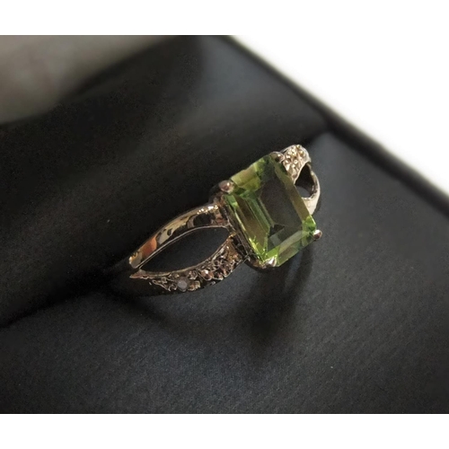 87 - 9ct yellow imported gold ring with octagon cut peridot & with small set diamonds to both shoulders

... 