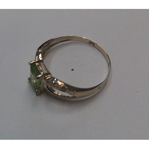 87 - 9ct yellow imported gold ring with octagon cut peridot & with small set diamonds to both shoulders

... 