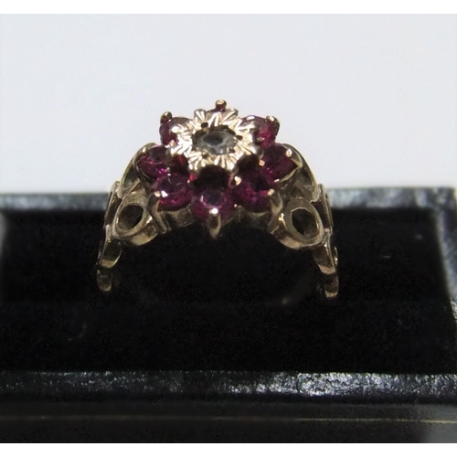 56 - Modernist 9ct yellow gold ruby cluster ring with unusual circular shoulders

Approx 3.2 grams gross,... 