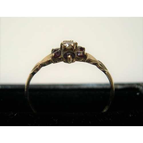 8 - 9ct yellow gold ruby flower ring 

Approx 1.2 grams gross              size N