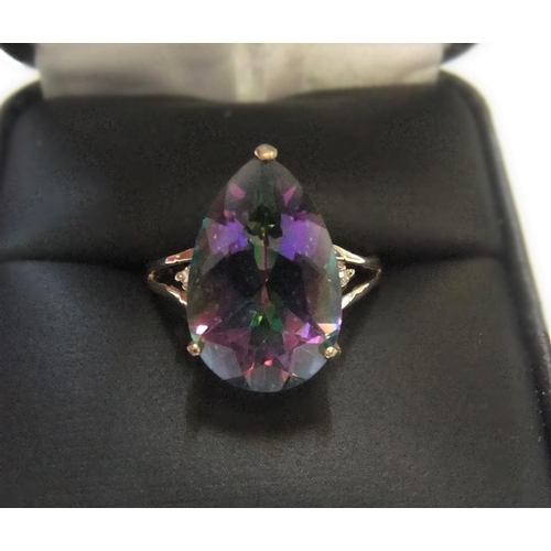 9 - 9ct yellow imported gold ring with large pear cut mystic topaz with a small diamond to either flank
... 