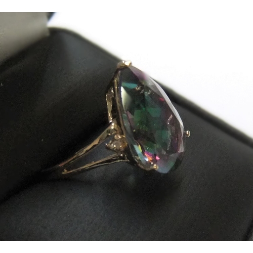 9 - 9ct yellow imported gold ring with large pear cut mystic topaz with a small diamond to either flank
... 