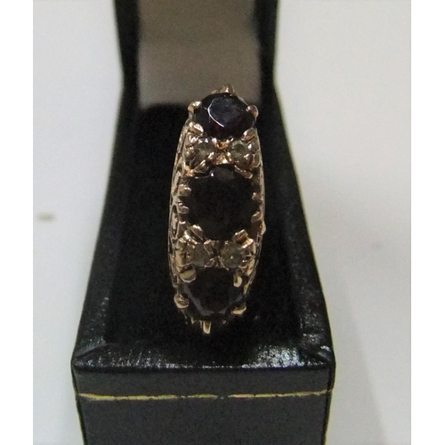 46 - 9ct yellow gold 3 stone garnet ring

Approx 3.9 grams gross,            size K/L