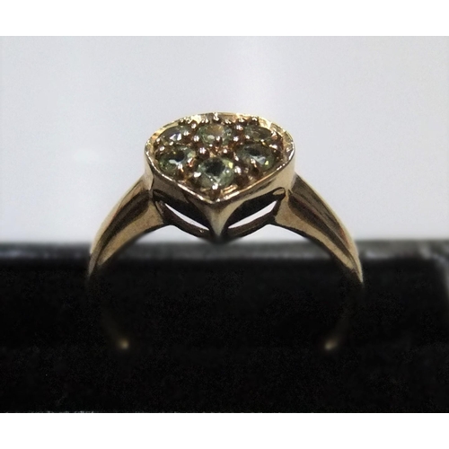 76 - 9ct yellow gold, heart shapped ring filled with green stones (probably peridots) 

Approx 2.2 grams ... 