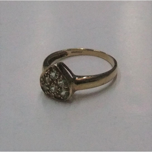 76 - 9ct yellow gold, heart shapped ring filled with green stones (probably peridots) 

Approx 2.2 grams ... 