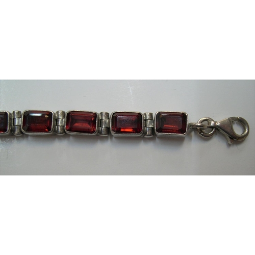 115 - Silver bracelet with red stone panels, 20cms long